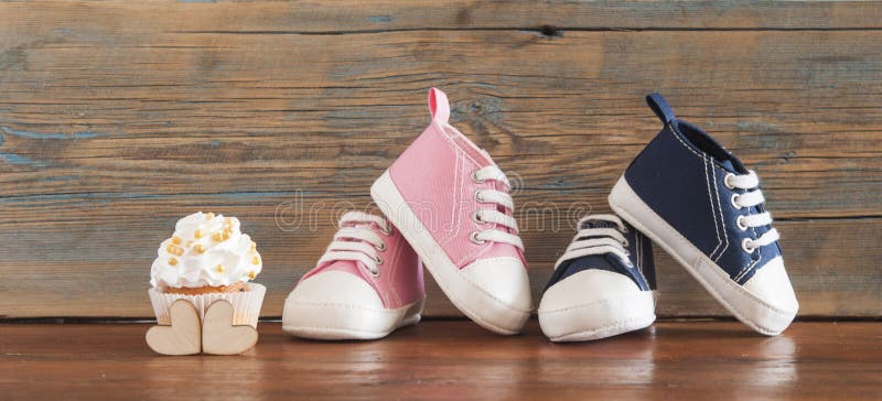 Delicious birthday сupcakes for a baby shower on wooden background